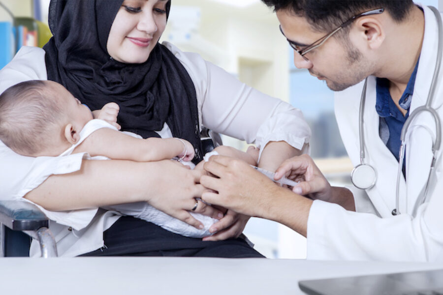 Pediatrician giving vaccine to baby boy