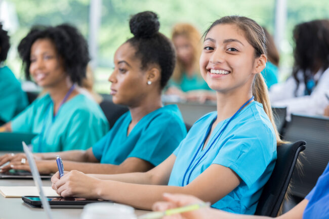 Smiling nursing student attends lecture